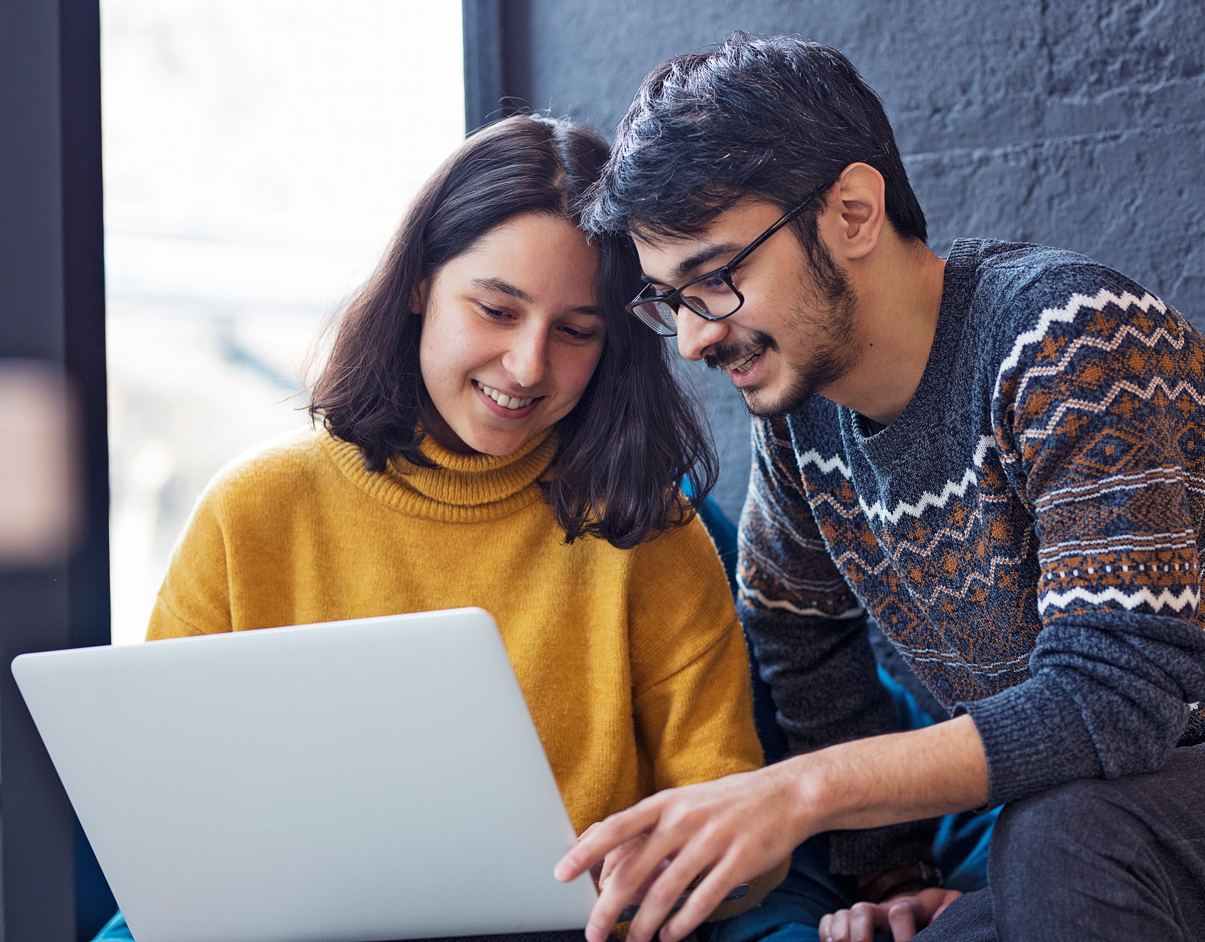 Two aspirants preparing together at a laptop